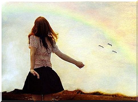 woman-looks-at-the-sky-with-rainbow-permits