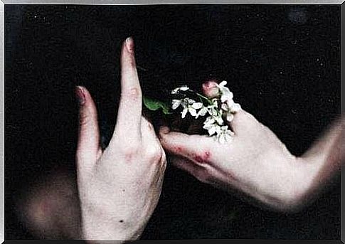 Hands with flowers symbolize a woman on the path of coping with emotions