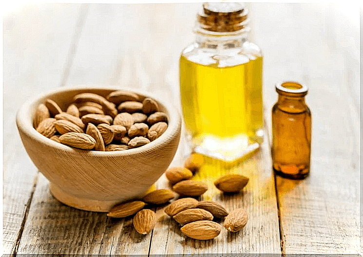 A bottle of vitamin E and a bowl of almonds.